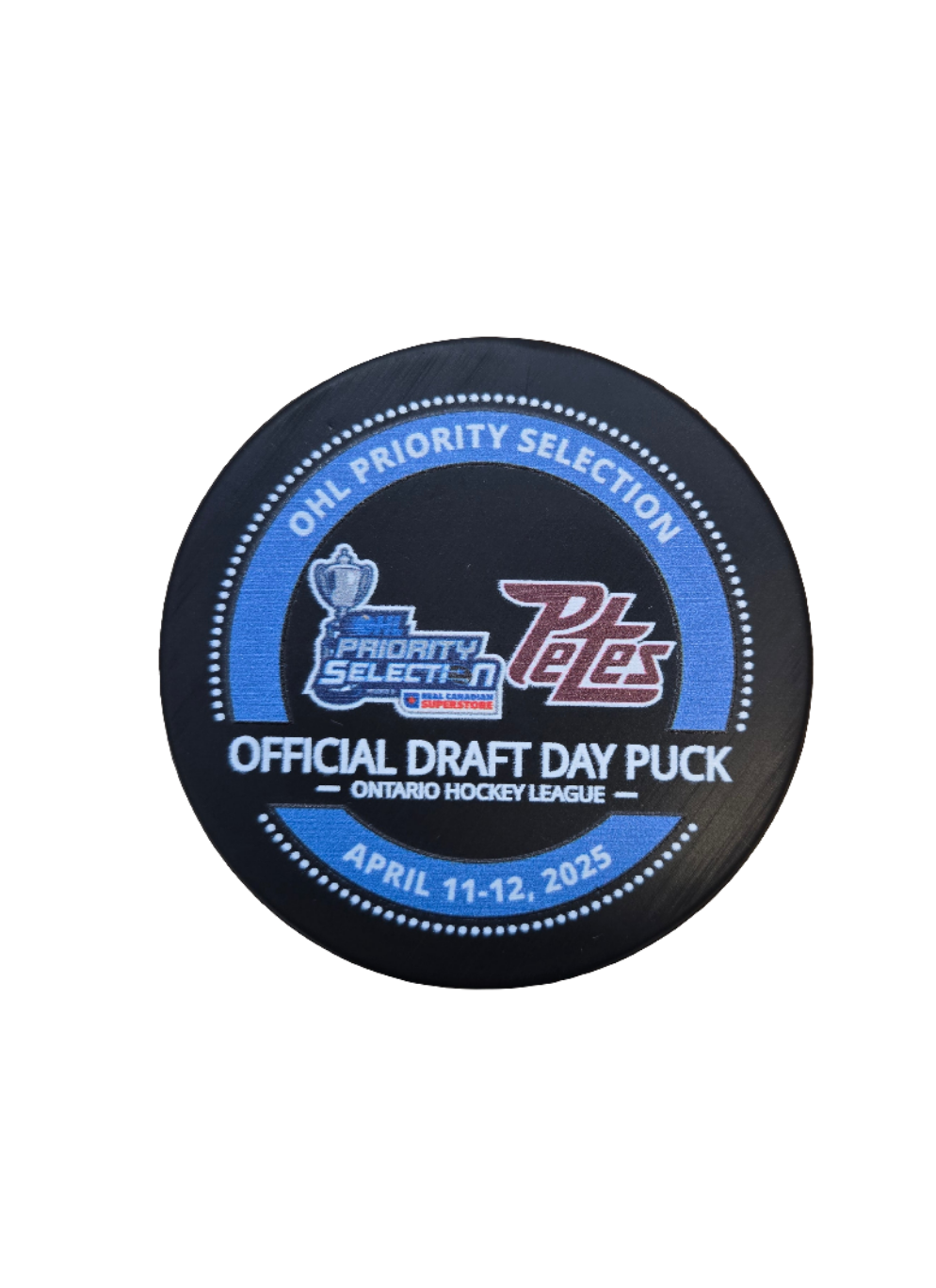 A hockey puck with the text '2025 OHL Priority Selection', 'Peterborough Petes' logo, and the date 'April 11-12, 2025'.