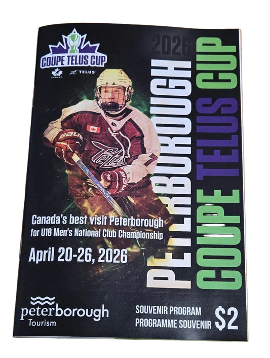 Program 2026 Peterborough Coupe Telus Cup hockey event on a wooden surface.