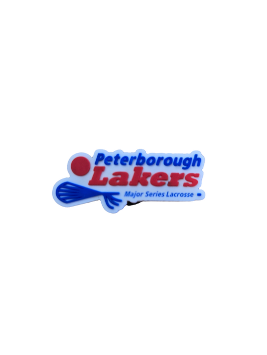 A rubber clog charm featuring the Peterborough Lakers logo in blue and red.