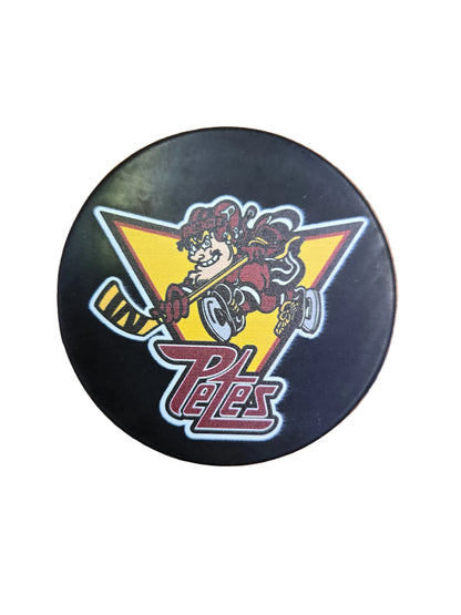 Hockey player mascot puck with a logo featuring a cartoon character and Petes logo